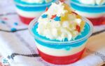 small desserts with red, white and blue frosting on a tablecloth are ready to be eaten