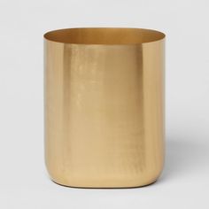 a gold colored vase on a white background