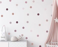 a baby's room with pink and brown polka dot decals on the wall