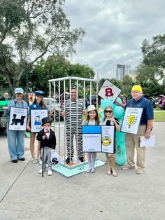 a group of people standing around each other holding signs