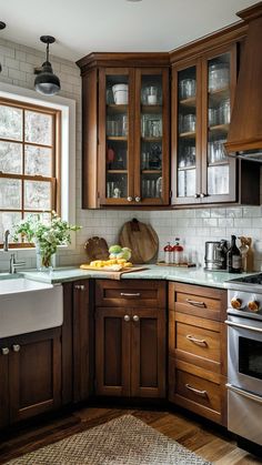 a kitchen with wooden cabinets and stainless steel appliances