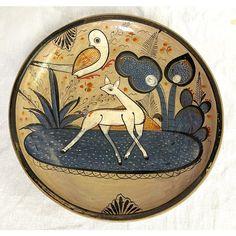 a bowl with an image of a deer and bird on it