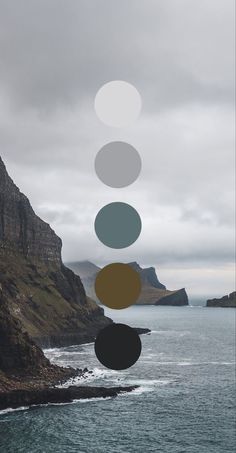 an image of the ocean and mountains with circles above it that are floating in the air