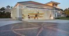 an open garage with two planes in the back and one on the front door at dusk