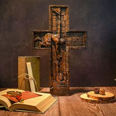 the cross is made out of wood and has been placed on top of an open book