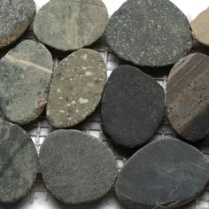 several different types of rocks sitting on top of a metal grating netted surface