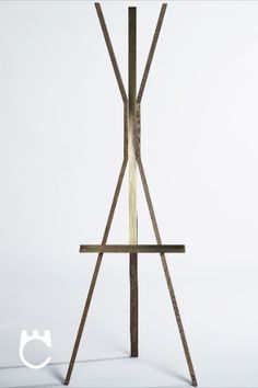 a wooden easel sitting on top of a white floor