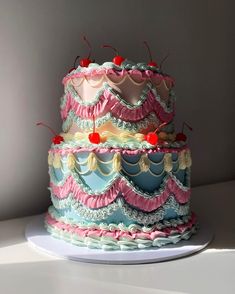 a three tiered cake with pink and blue icing