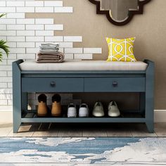 a blue bench with shoes on it in front of a mirror and tiled wall behind it