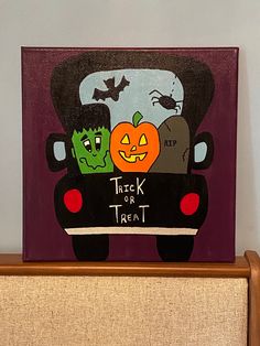 a trick or treat painting on top of a dresser