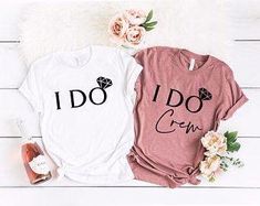 two t - shirts that say i do and i do crew on them next to some flowers