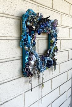 a blue wreath hanging on the side of a white brick wall