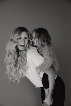 two women are hugging each other in black and white