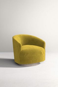 a yellow chair sitting on top of a white floor