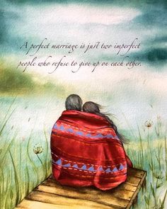 two people wrapped up in blankets sitting on a wooden bench with grass and water behind them