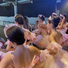 a group of young ballerinas in pink dresses