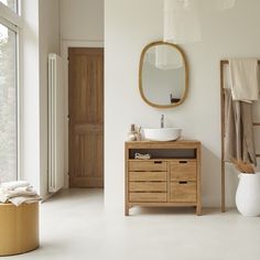 a bathroom with a sink, mirror and towel rack