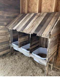 the inside of a chicken coop with two bins on each side and one in the middle