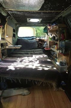 the inside of an rv with two beds and other items in it's storage area