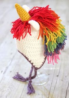 a crocheted unicorn hat with multicolored hair