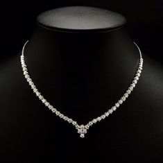 She'll never tire of wearing this classic and sophisticated diamond tennis necklace. Stunning in 18K solid white gold, this breathtaking line of shimmering round diamonds. So elegant, this 18.0-inch diamond necklace will take her breath away. Radiant with 3.08 cts. t.w. of diamonds and buffed to a brilliant luster, this glamorous keepsake secures with a box clasp. The setting design make the diamonds look much bigger than they are. When worn, the diamonds look like 1/5 carat each. Diamonds Detai Luxury Diamond White Diamond Necklace For Party, Luxury Diamond White Solitaire Necklace For Anniversary, Luxury Diamond White Diamond Necklace Hallmarked, Luxury Diamond White Diamond Necklace With Polished Finish, Luxury White Gold Diamond Necklace With Brilliant Cut, Luxury White Gold Diamond Necklace With Round Stone, Luxury Diamond White Round Cut Bridal Necklace, Luxury White Gold Necklace With Single Cut Diamonds, Luxury Diamond White Necklace For Celebration