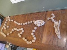 a wooden table topped with lots of beads