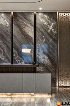 an elegant lobby with marble walls and flooring