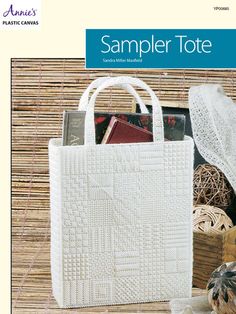 a white bag sitting on top of a wooden table next to a pile of books