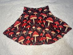 🍄 Our Mushroom Magic Skirt is an adorable piece that's perfect for anyone who loves the whimsical vibes of nature. With its enchanting mushroom print and cottagecore aesthetic, this skirt is sure to bring a touch of magic to your wardrobe. Whether you're dressing up for a festival or keeping it casual for a day out, this skirt offers endless possibilities for expressing your unique style. 🎁 Looking for a special gift? This skirt is a wonderful choice for nature lovers, mushroom enthusiasts, or anyone who appreciates the beauty of the forest. Available in sizes XS - 2XL, it's designed to fit comfortably while showcasing that charming fairycore and forestcore aesthetic we all adore. 🌲 Crafted with care right here in the USA, this skirt is made from a soft and stretchy blend of 95% polyest Mushroom Skirt, Stil Rock, Forestcore Aesthetic, Boho Style Skirts, Skirt Cottagecore, Magic Skirt, Mushroom Magic, Vintage Boho Style, Cottage Core Dress