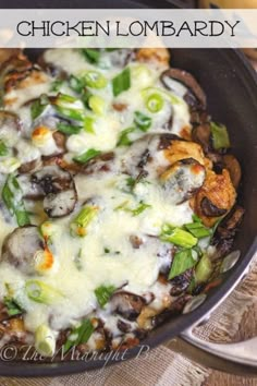 a casserole dish with mushrooms, green onions and cheese on it in a pan