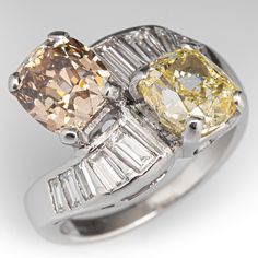 two yellow and white diamond rings with baguettes on the sides, set in 18k white gold