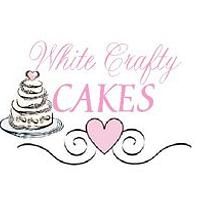 a white cake with pink hearts on it and the words white crafty cakes above it