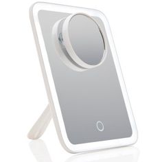 an electronic device with a circular mirror on it's back end and one button in the middle