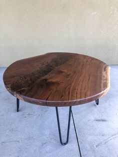 a wooden table sitting on top of a white floor