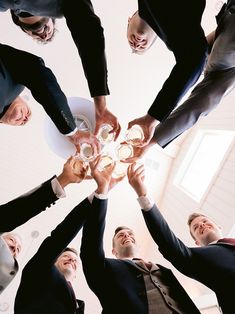 a group of people standing around each other holding hands in the middle of a circle