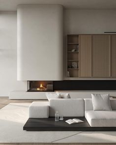 a modern living room with white furniture and fireplace