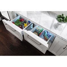 an open drawer in the middle of a kitchen counter