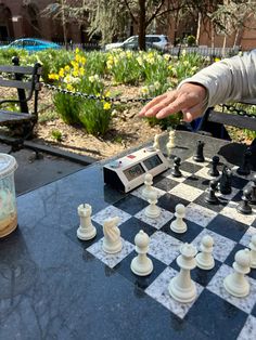 a man is playing chess in the park