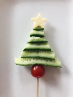 a christmas tree made out of cucumber and tomato on a toothpick