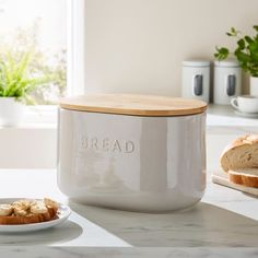 a loaf of bread sitting on top of a counter next to a white canister