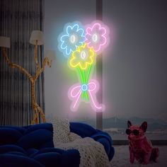 there is a neon sign with flowers on it next to a dog sitting in front of the window