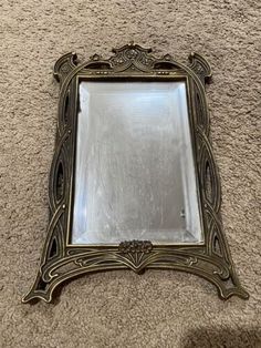 a mirror sitting on top of a carpeted floor