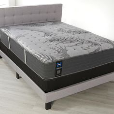 two mattresses sitting next to each other in a room