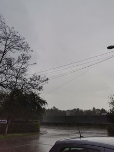 a car is parked in front of a flooded street