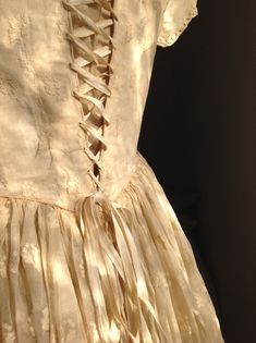 "very very old wedding dress from about 1840s  in a  cream gold color the transparant cotton fabric has beautiful silk embroidery ( flower )work. the bodice part of this dress is fully lined with a cotton inner layer. and it has bones condition: and there are some little wounds in the upper layer of the bodice some of the wounds are repaired, some are still open.But protected by the inner layer. Only when you come close by you'll see them I've never seen a beauty like this.... measurements: bust