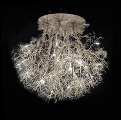 a chandelier made out of branches and lights