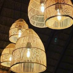 three hanging lights made out of wicker baskets