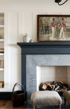 a fire place in a living room with a painting on the wall