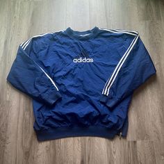 Vintage 1990s Adidas Windbreaker Jacket  - Size XXL (Length 29.5", Chest 28") - Overall great vintage condition (small stains pictured) - Message for more information Please take note of the measurements listed as these are vintage clothes and may fit different than the tag size. Follow our page for more vintage clothing drops! DISCLAIMER: All items are vintage so please be mindful that if by chance there is a flaw on the item we simply may have just missed it. Inquire for more product informati Adidas 90s Coat, Retro Oversized Crew Neck Outerwear, 90s Inspired Long Sleeve Fall Outerwear, 90s Inspired Long Sleeve Streetwear Outerwear, 90s Crew Neck Outerwear For Fall, 90s Style Outerwear With Crew Neck For Fall, 90s Style Sports Outerwear With Crew Neck, 90s Style Fall Windbreaker For Streetwear, 90s Style Long Sleeve Track Jacket For Fall