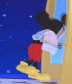 the mickey mouse is looking at himself in the mirror